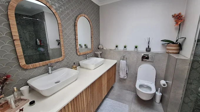 Modern bathroom tiling with double basin and clean wall finish