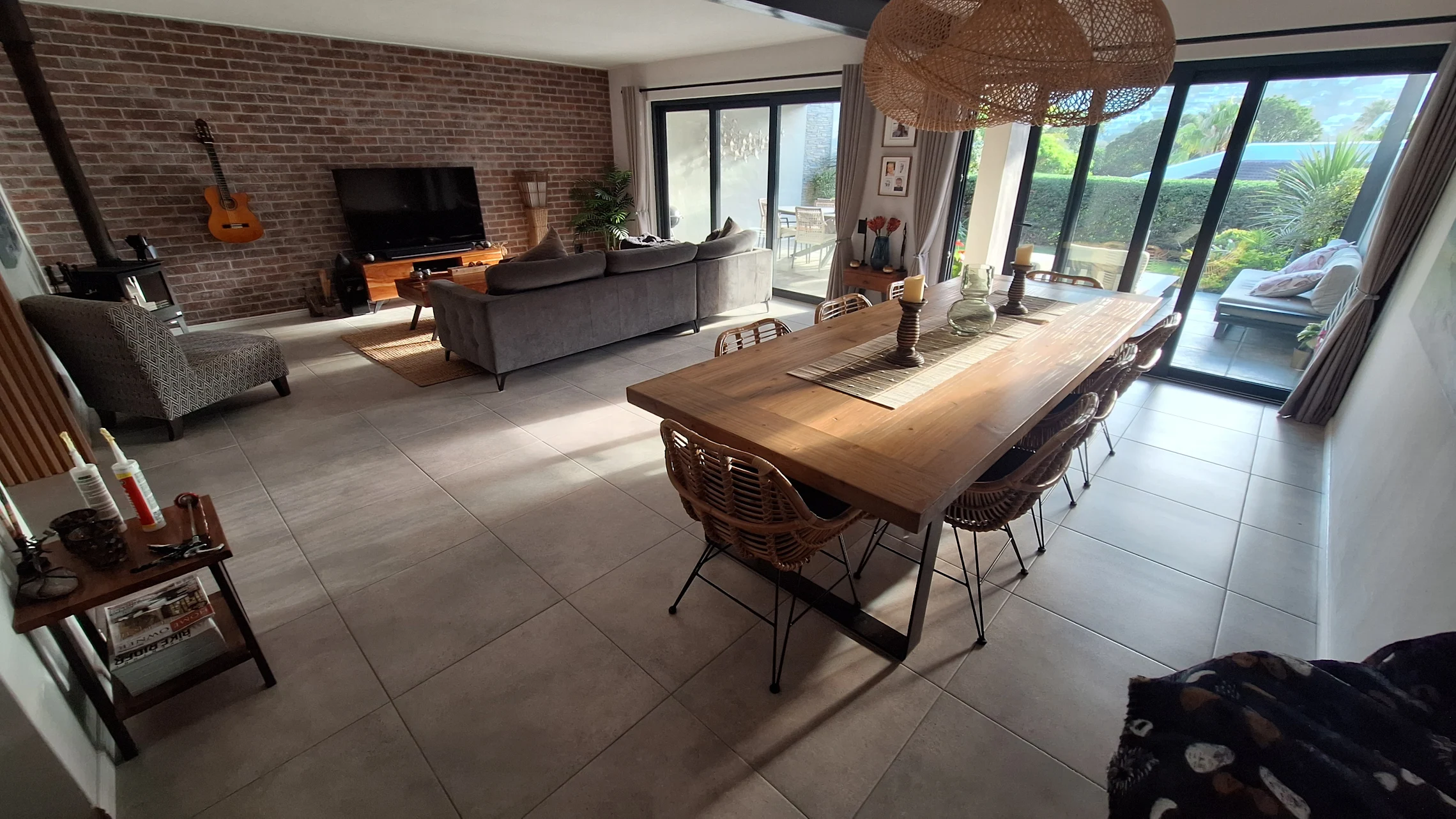 Open-plan living and dining area with large floor tiles and clean room transitions