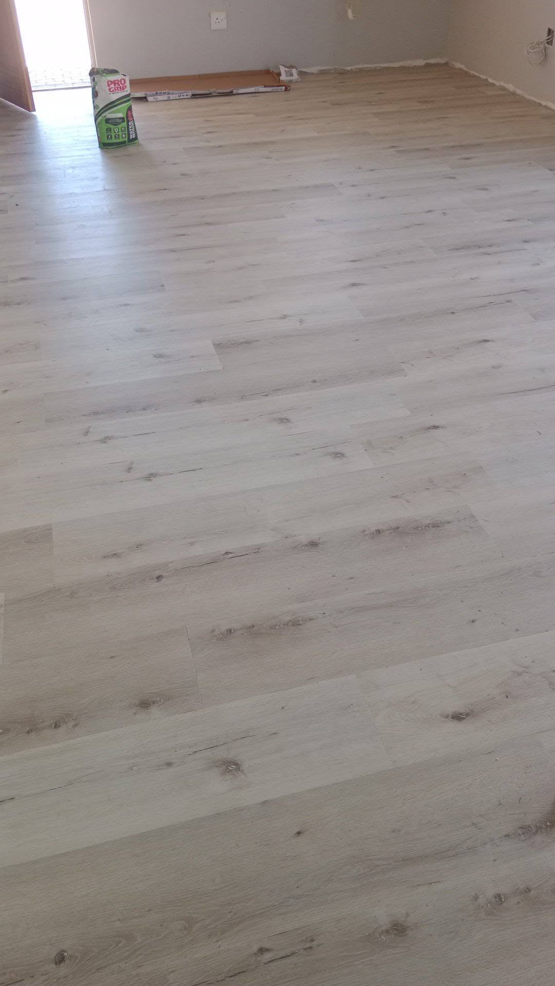 Light oak vinyl flooring installed across a room with clean plank alignment